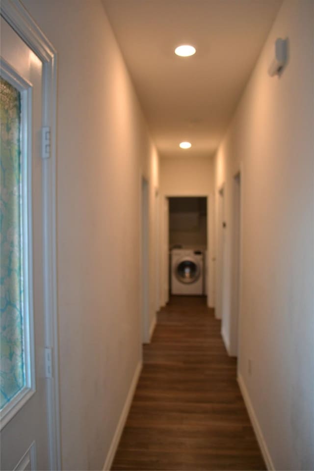 hall featuring dark hardwood / wood-style flooring and washer / dryer