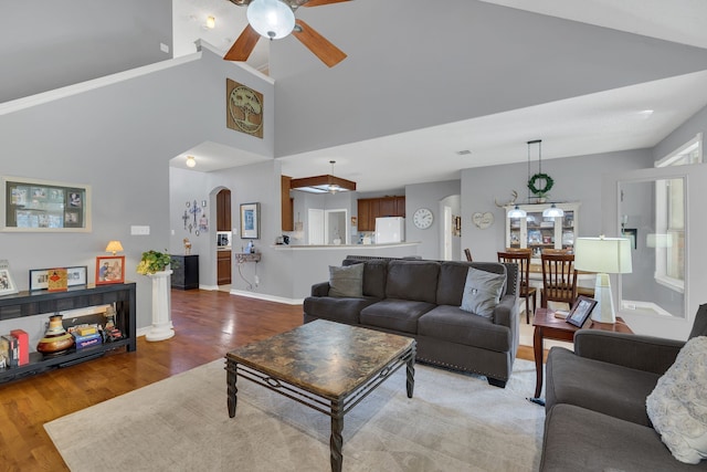 living room featuring hardwood / wood-style floors, ceiling fan, and high vaulted ceiling