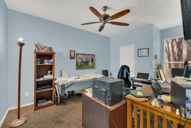 carpeted office with ceiling fan and a textured ceiling