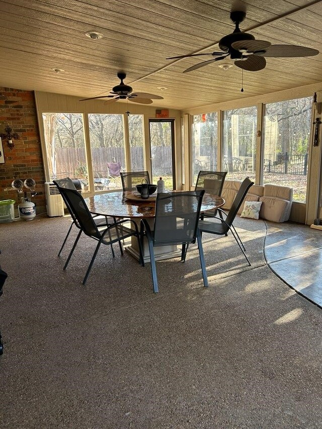 sunroom / solarium with ceiling fan and wooden ceiling