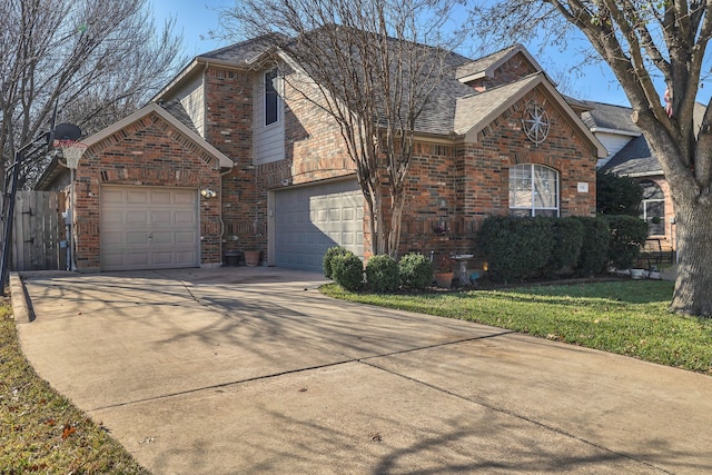 view of front property featuring a garage and a front lawn