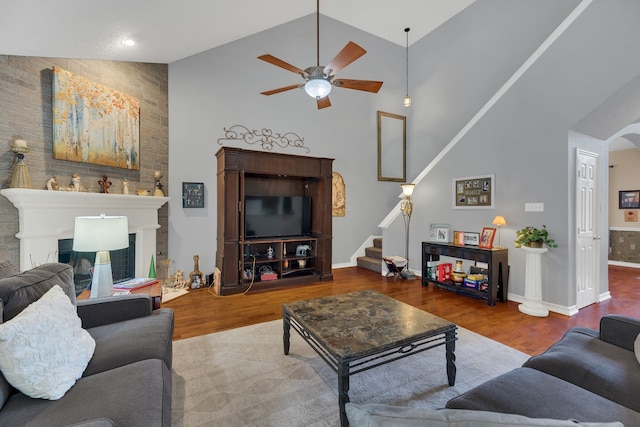 living room with ceiling fan, hardwood / wood-style floors, and high vaulted ceiling