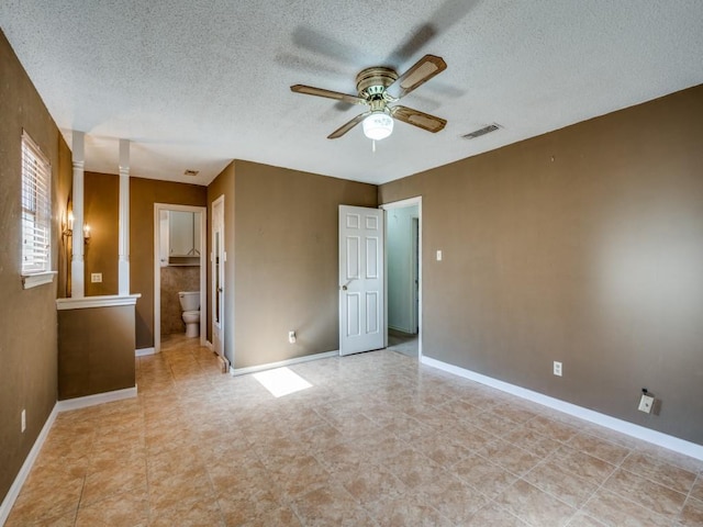 unfurnished bedroom featuring ceiling fan, ensuite bathroom, and a textured ceiling