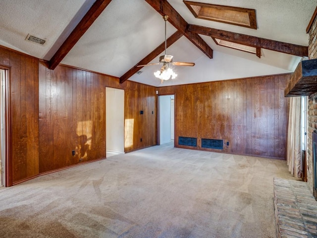 unfurnished living room featuring light carpet, ceiling fan, and wood walls