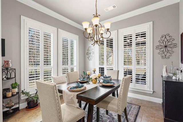 tiled dining room featuring ornamental molding and an inviting chandelier