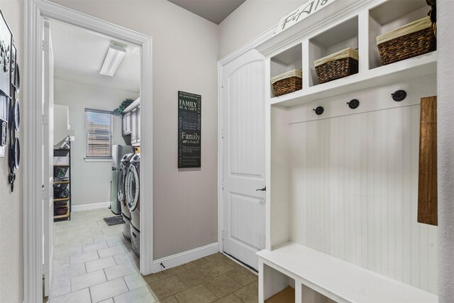 mudroom with light tile patterned flooring and separate washer and dryer