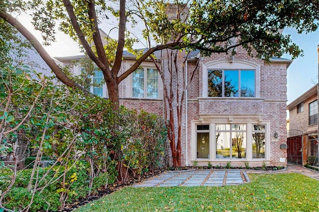 rear view of property featuring a yard