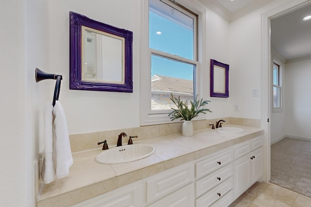 bathroom featuring tile patterned flooring, vanity, and crown molding