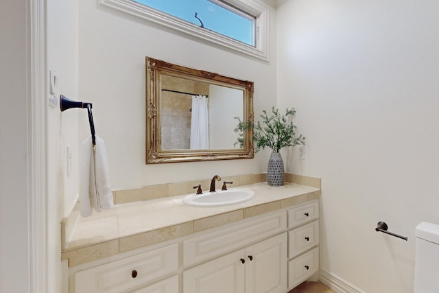 bathroom with vanity and toilet