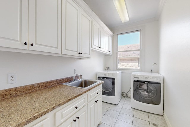 laundry room with sink, cabinets, crown molding, washer and clothes dryer, and light tile patterned floors