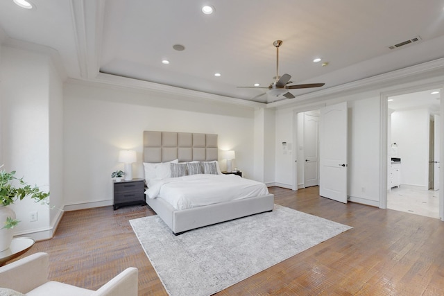 bedroom with light wood-type flooring, ceiling fan, and ornamental molding