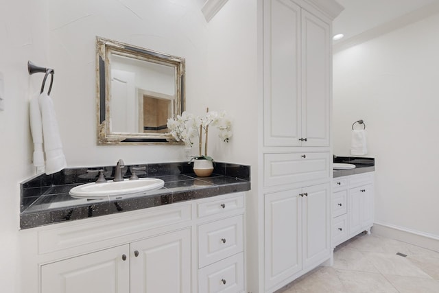 bathroom with tile patterned flooring, vanity, and crown molding