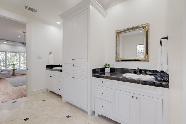 bathroom featuring vanity, tile patterned floors, and crown molding