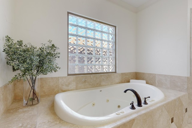 bathroom featuring ornamental molding and tiled tub