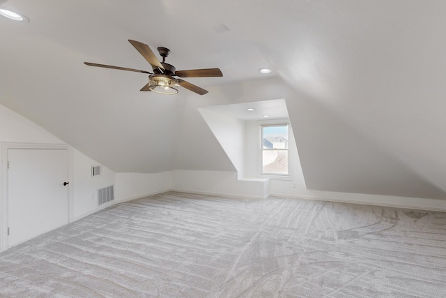 bonus room featuring ceiling fan, light colored carpet, and lofted ceiling