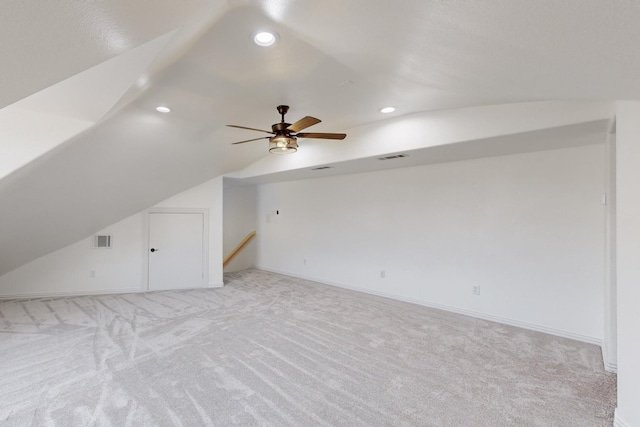 bonus room with ceiling fan, light colored carpet, and vaulted ceiling