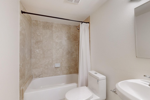 full bathroom featuring toilet, sink, and shower / tub combo with curtain