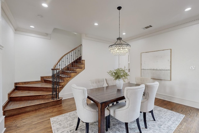 dining space with a notable chandelier and wood-type flooring