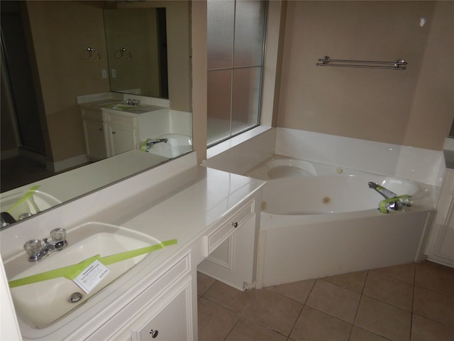 bathroom featuring vanity, tile patterned floors, and a tub