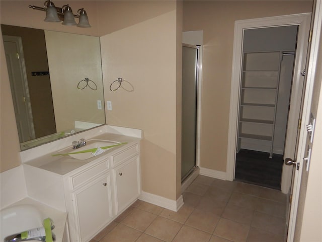 bathroom with tile patterned flooring, vanity, and a shower with shower door