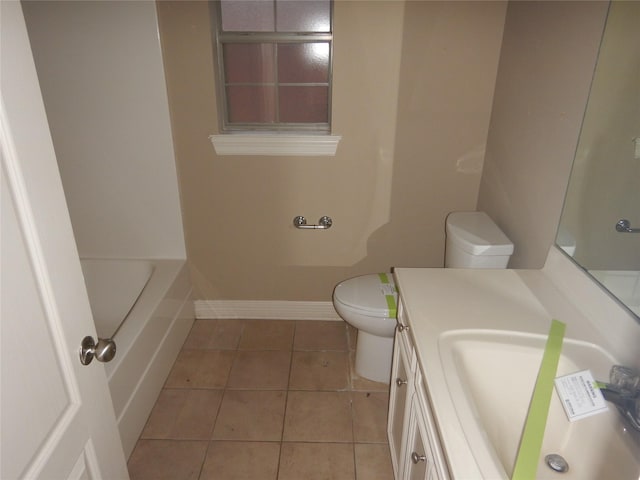 bathroom featuring tile patterned flooring, vanity, a washtub, and toilet