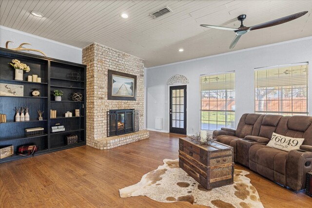 living room featuring hardwood / wood-style flooring and ornamental molding