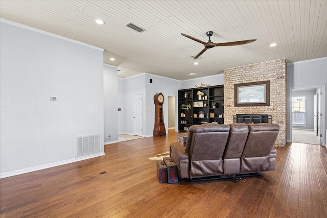 living room with ceiling fan, wood-type flooring, crown molding, and wood ceiling