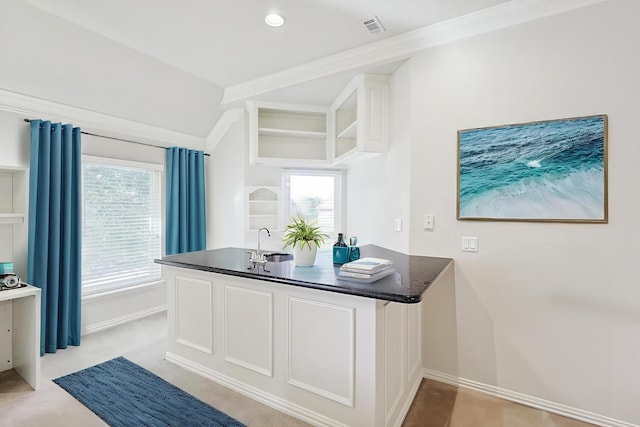 bathroom featuring plenty of natural light, crown molding, and sink