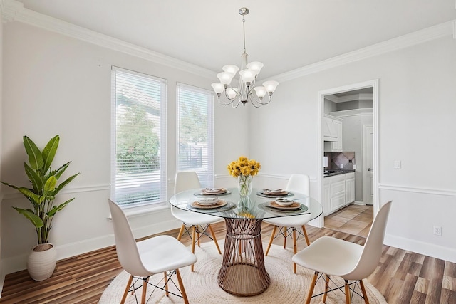 dining room with a wealth of natural light, crown molding, and light wood-type flooring