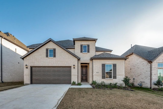 view of front of home featuring a front lawn and a garage