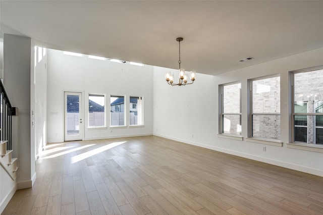 interior space with light hardwood / wood-style floors and a chandelier