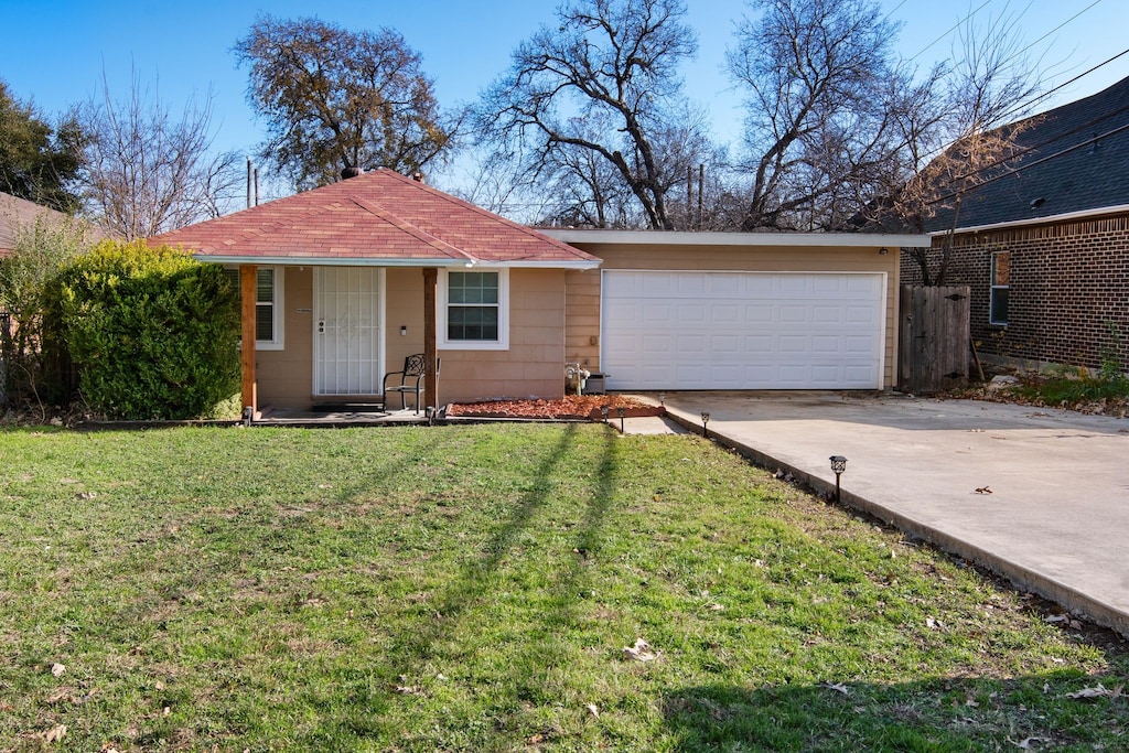 ranch-style home featuring a garage and a front yard