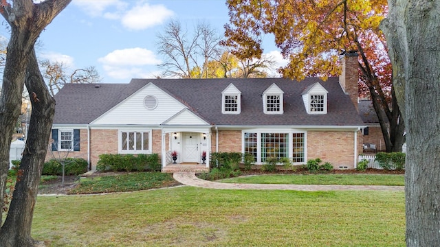 cape cod-style house with a front lawn