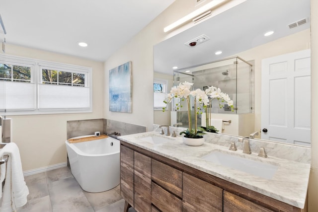 bathroom featuring vanity and shower with separate bathtub