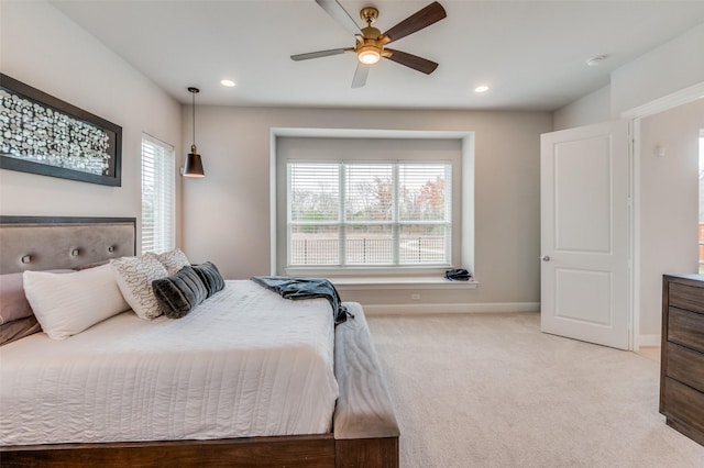 carpeted bedroom with multiple windows and ceiling fan