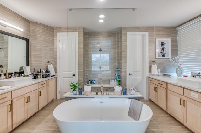 bathroom featuring vanity and tile walls