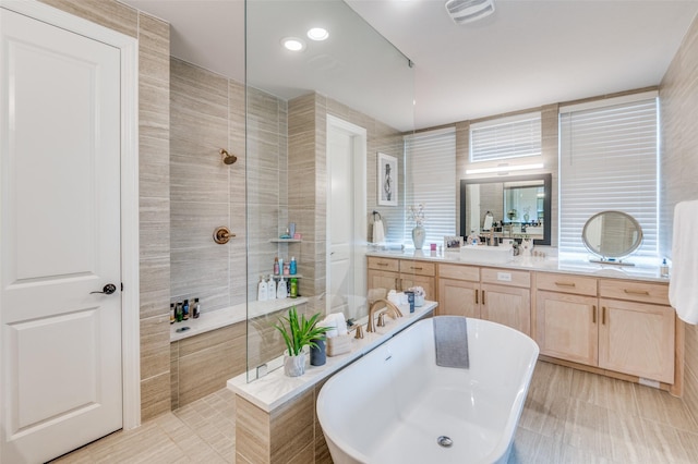 bathroom featuring vanity, tile walls, and a tile shower