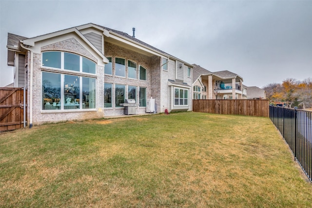 rear view of house featuring a lawn