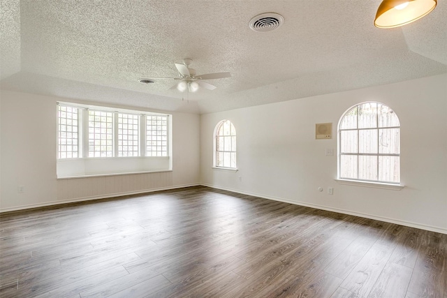 spare room with dark hardwood / wood-style flooring, a textured ceiling, and ceiling fan