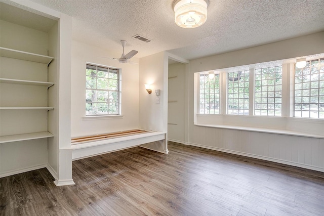 interior space with hardwood / wood-style floors, a textured ceiling, and ceiling fan