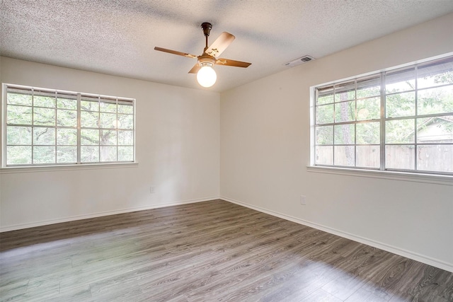 unfurnished room with ceiling fan, hardwood / wood-style floors, and a textured ceiling