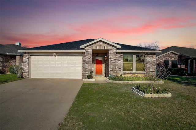 view of front of property with a yard and a garage