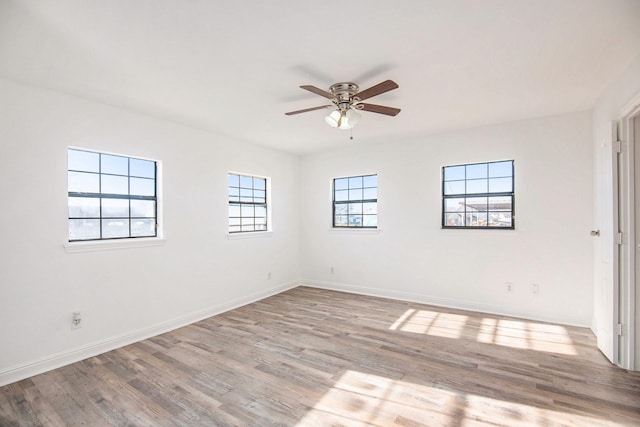 empty room featuring ceiling fan and light hardwood / wood-style flooring