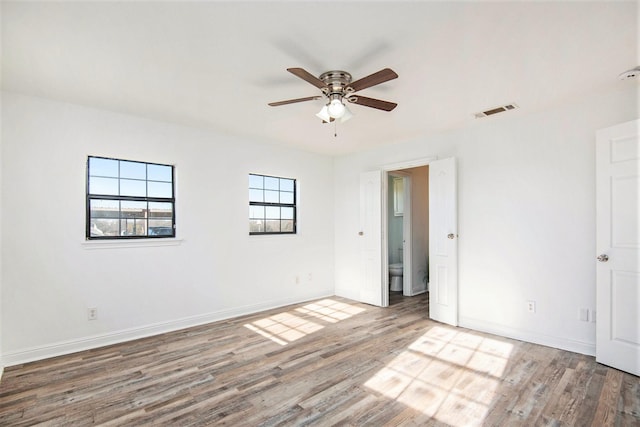 empty room with hardwood / wood-style flooring and ceiling fan