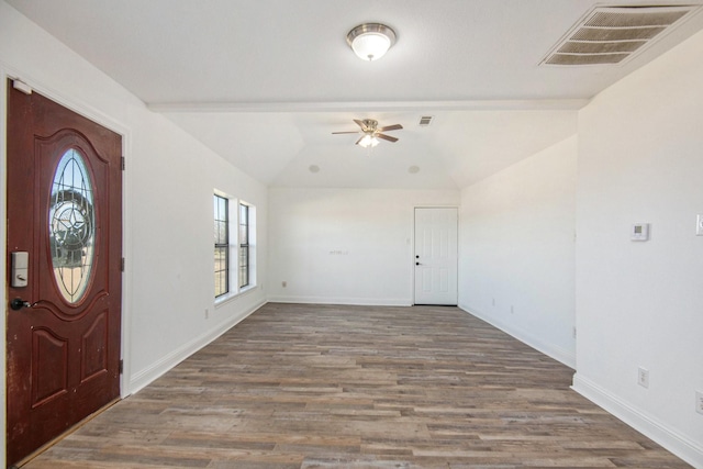 foyer with ceiling fan, wood-type flooring, and vaulted ceiling