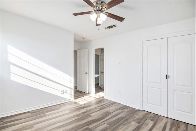 unfurnished bedroom featuring light hardwood / wood-style flooring, a closet, and ceiling fan