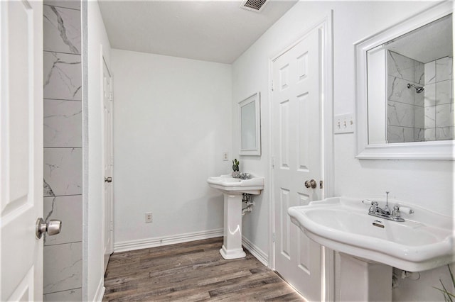 bathroom with hardwood / wood-style floors