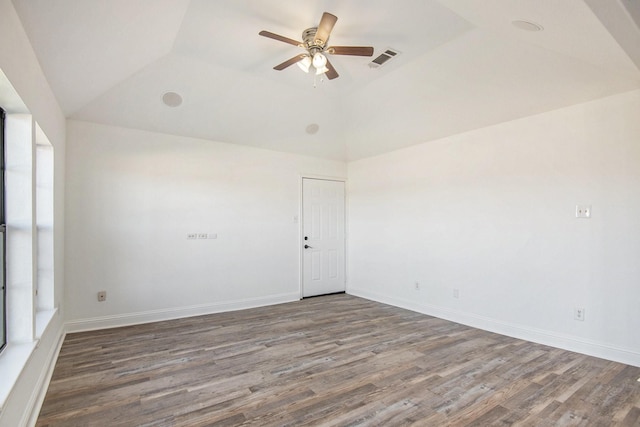 empty room featuring ceiling fan, dark hardwood / wood-style flooring, and vaulted ceiling