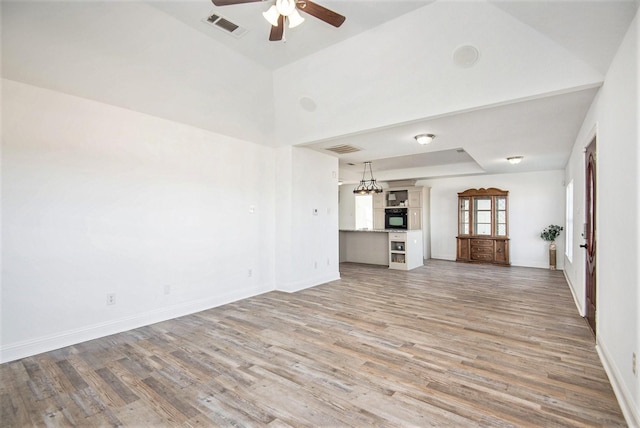 unfurnished living room featuring wood-type flooring and ceiling fan