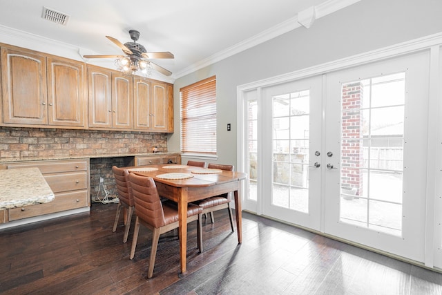 dining room featuring french doors, crown molding, ceiling fan, and dark wood-type flooring